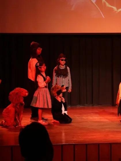A dramatic scene from 'The Wizard of Oz' under red lighting. We use simple technical elements like lighting to enhance the mood and atmosphere of our productions.