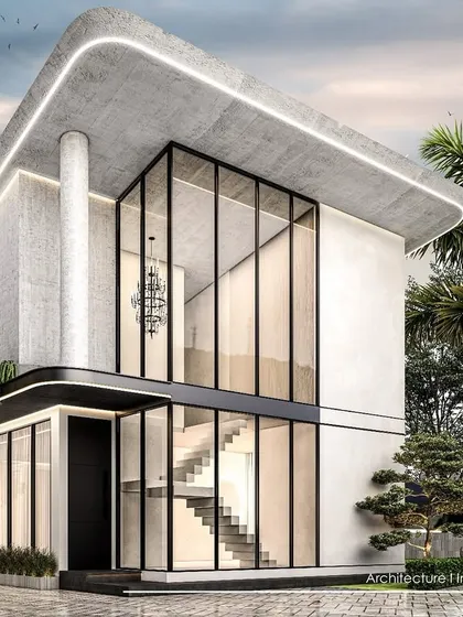 A close-up view of the Goa villa concept, detailing the double-height glass entryway and the smooth, rounded edges of the concrete structure.
