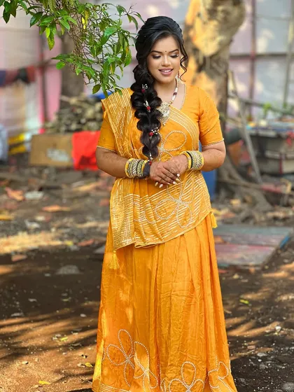 A full-length shot of the bride in her simple and beautiful yellow Haldi outfit.