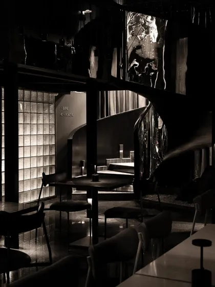 Mystery is a powerful tool in spatial storytelling. For this speakeasy, I designed a journey of concealment and revelation, where a spiraling staircase of black steel and distorted reflections guides patrons into a hidden world, making the arrival as compelling as the destination.