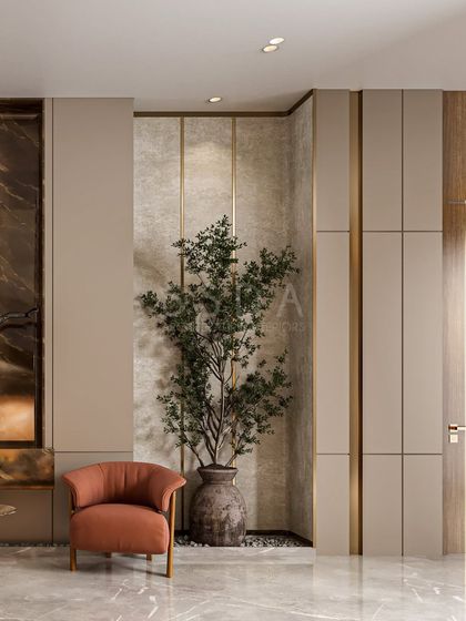 Another view of the material layering, highlighting how the neutral paneled walls and stone niche create a calm backdrop for the sculptural plant and armchair.