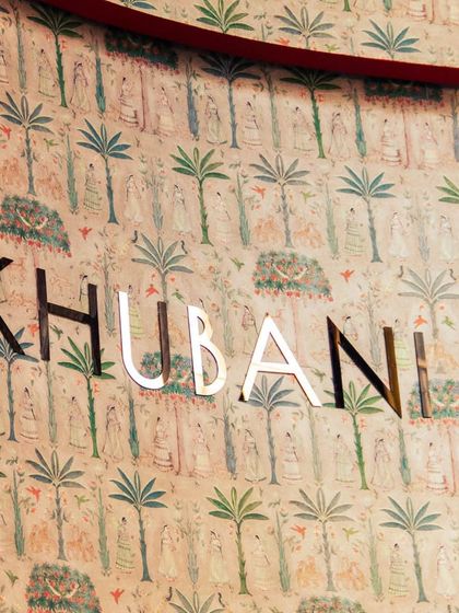 This close-up of our logo against the artistic wallpaper captures the essence of Khubani. Every corner is a canvas, with intricate motifs and cultural symphonies that create an ethereal and sophisticated interior.