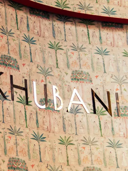 Our name, set against a backdrop of hand-painted wallpaper, serves as an introduction to the world of artistry and sophistication that we have curated for our guests.