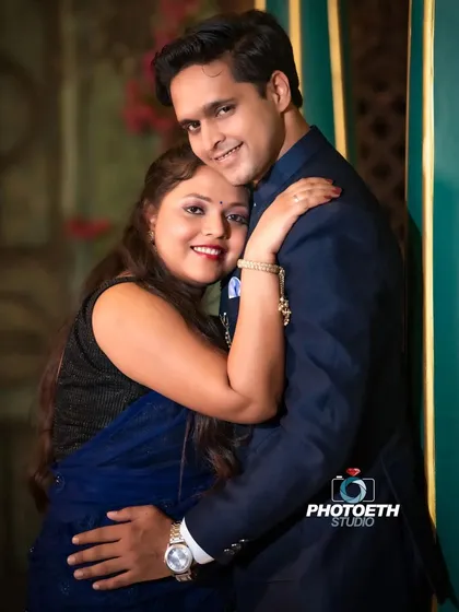 A warm and affectionate indoor portrait. The simple, loving hug and the couple's happy smiles make this a beautiful and timeless image.