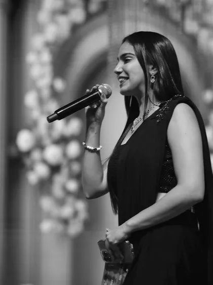 A black and white shot capturing a moment on stage. As an event host, I connect with the audience through my words and presence, ensuring the energy in the room is always high and the focus remains on the celebration.