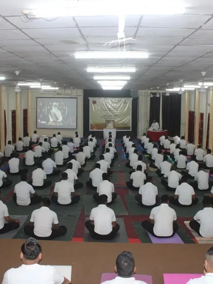 The stillness and unity in a large hall during an Army yoga session. Each participant is fully engaged, creating a powerful atmosphere for transformation.