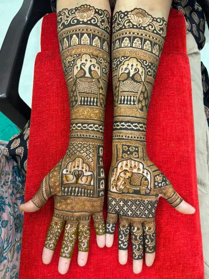 Another look at a full bridal design, showcasing the balance between figurative work like peacocks and elephants, and the geometric patterns that fill the hands and arms.