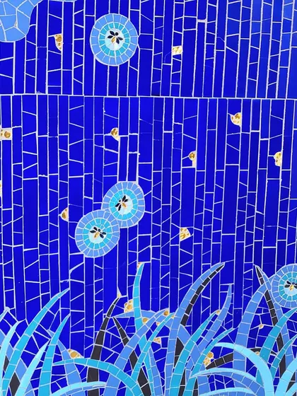A close-up of a vibrant blue mosaic mural from a project in Goa. The intricate tilework and touches of gold create a rich, textured surface that tells a story of its coastal context.