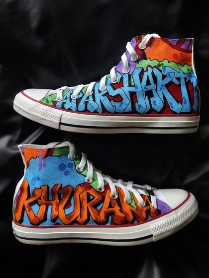 The full pair of graffiti custom Converse, with "APARSHAKTI" on one shoe and "KHURANA" on the other.