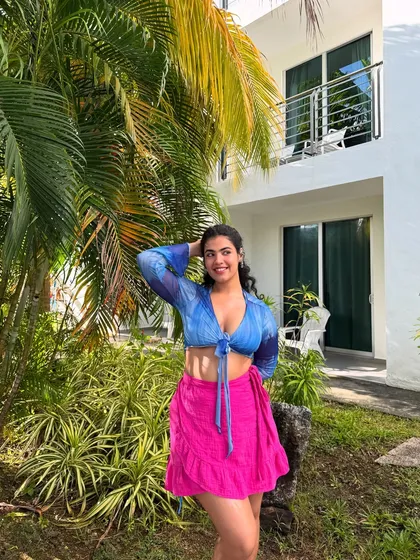 Me and my one brain cell on an island. This colorful look with a blue tie-front top and a bright pink skirt is all about dopamine dressing. Vacation is the perfect time to play with bold color combinations.