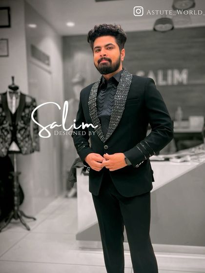 A client in a black blazer with a sequined lapel and cuff detail. The matching black shirt creates a sleek, all-black look that is very popular for evening events.