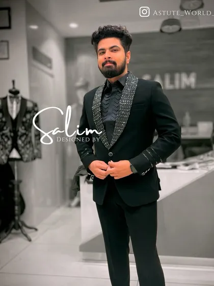 A client in a black blazer with a sequined lapel and cuff detail. The matching black shirt creates a sleek, all-black look that is very popular for evening events.