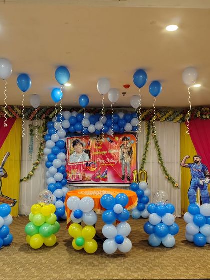 A full view of the cricket-themed party stage. I arrange everything from the backdrop and balloons to the placement of the character cutouts to create a complete look.