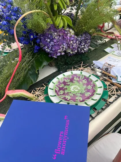 A tablescape detail from the Farm Rio brunch, with lush florals and bold, printed plates. The design captures the lively and nature-inspired spirit of the brand.