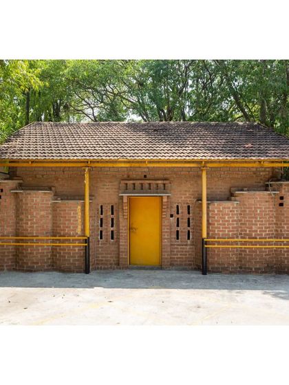 The exterior of the classroom we designed for the Spastic Society of Karnataka in Bengaluru. Originally a temporary structure, this building made of mud blocks has stood for decades, proving the durability of ecological materials.