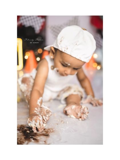 The messy hands of a little racer after his cake smash. These are the fun, candid moments that make the best memories.