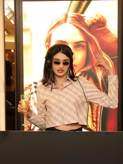 Posing at the Burberry event. For high-fashion clients, the look and feel are paramount, and I make sure my presence complements the brand's aesthetic.