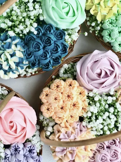 A close-up of my floral cupcakes, perfect for Raksha Bandhan. Each one is a moist, egg-free Belgian chocolate cupcake swirled with signature vanilla buttercream and hand-decorated to look like a vibrant bouquet.