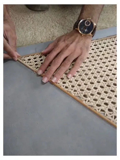 Craftsmanship is at the heart of my work. This image shows the meticulous process of inlaying handwoven cane, a natural material that adds texture and a retro feel to modern furniture. I collaborate closely with skilled artisans to bring these details to life.