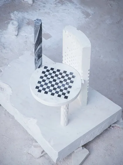 An overhead view of the Dori Patti chair on a raw block of marble. This perspective shows the piece as a functional sculpture, a piece of art born from the earth.