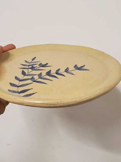 An angled view of the hand-painted plate, showing its gentle curve and rustic charm. Each piece is handmade with love in my Mumbai studio.