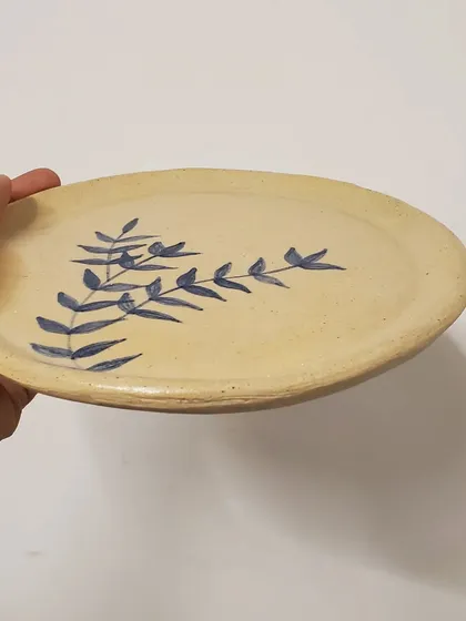 An angled view of the hand-painted plate, showing its gentle curve and rustic charm. Each piece is handmade with love in my Mumbai studio.