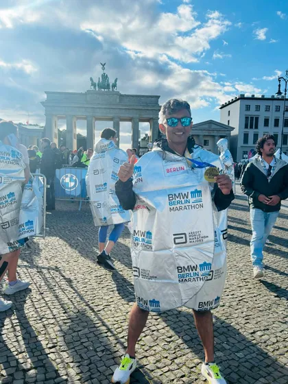 Victory at the Brandenburg Gate. An athlete celebrates finishing the Berlin Marathon, one of the fastest marathon courses in the world.