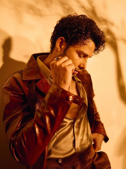 The soft sheen of the satin shirt against the matte leather jacket is highlighted in this shot of Siddhant Chaturvedi. It’s all about the interplay of light and texture.