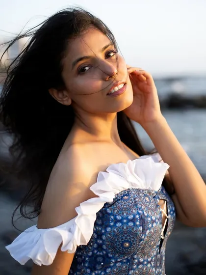 For editorial and concept shoots, I bring a softer, more evocative energy. This golden hour portrait from a beach shoot highlights a custom-designed corset top, showing my capability for fashion storytelling.