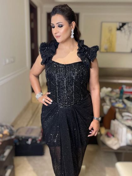 The full view of this stunning client, where the smokey eye makeup perfectly complements her sparkling black dress.