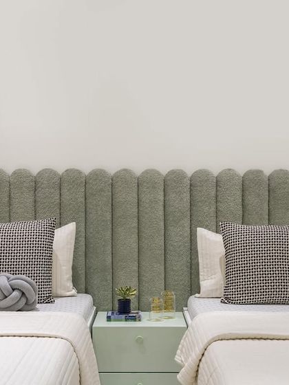 We created a whimsical wonderland for the children's bedroom. Featuring a charming scalloped headboard in a soothing light green hue, this space is designed to inspire imagination and creativity.