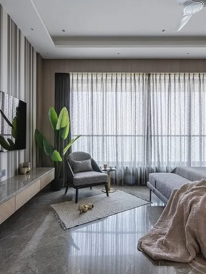 A wide shot of the bedroom in 'Aria Residence', showing the balance between the bold red headboard, striped wallpaper on the TV wall, and the ample natural light from the large window.