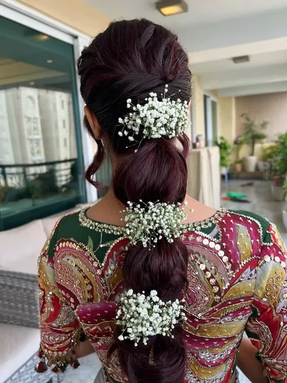 Another angle of the burgundy bubble braid, showing how the white baby's breath pops against the dark hair.