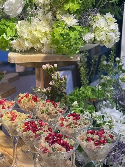 Quinoa salad served in elegant martini glasses and topped with pomegranate seeds. This is a healthy, gluten-free, and visually stunning option for any event.
