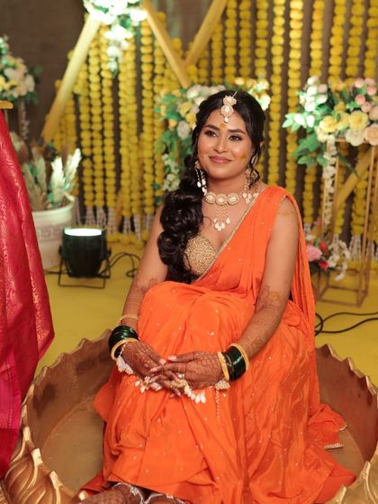 Our bubbly bride enjoying her Haldi ceremony. Her makeup is fresh and vibrant, designed to last through all the fun and festivities.