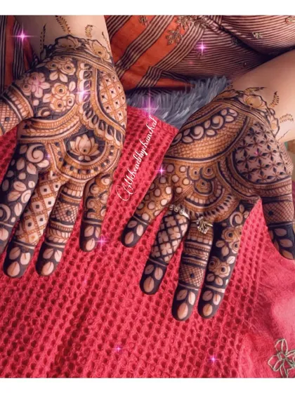 A lovely festive design with lotus motifs and a delicate ring chain connecting the index finger to the wrist.