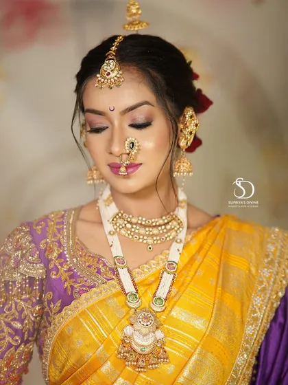 A close-up on the delicate makeup of a Maharashtrian bride. The soft pink eyeshadow, perfectly defined brows, and the traditional nath create a look that is both gentle and stunning.