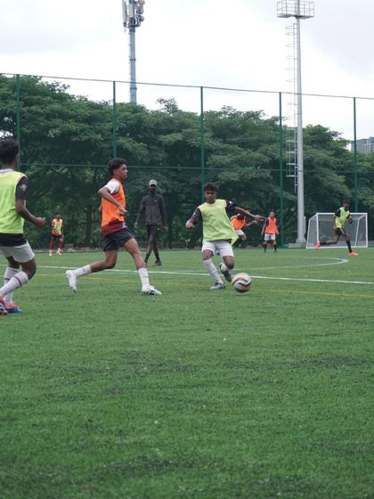 Players battling for possession during a trial game. We assess a player's work rate and defensive contribution just as much as their attacking skill.