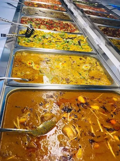 A feast of authentic Indian flavors. This is a top-down view of our buffet spread, featuring a variety of rich curries and flavorful rice dishes.