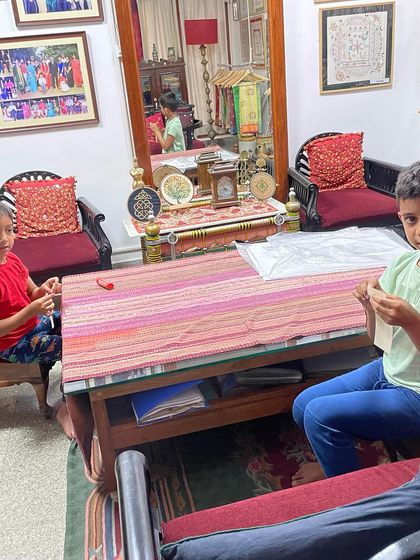 Another shot of my grandsons learning to stitch. The younger one is on the left, carefully pulling his thread, while the elder one works on his piece.