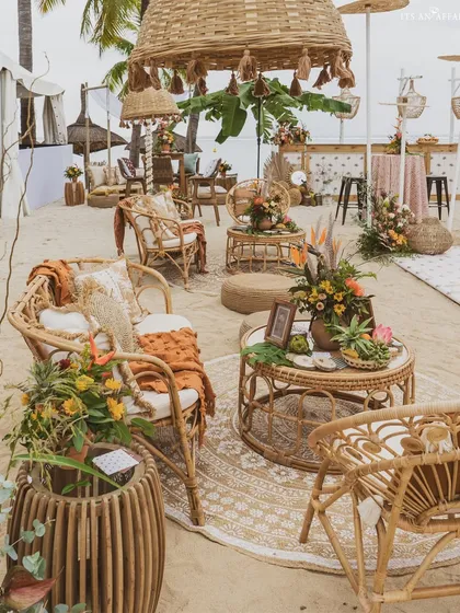 A lounge area with natural cane and wicker furniture, creating a comfortable and stylish spot to enjoy the ocean breeze.