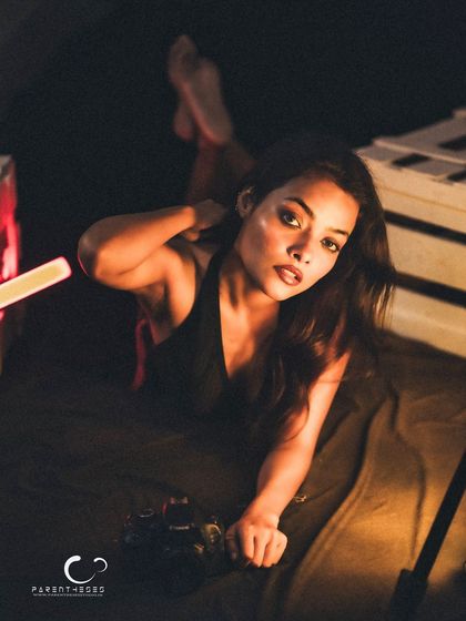 A dynamic and alluring pose that uses the entire frame. The composition is interesting, and the mood is intimate and captivating.