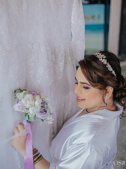 Moments before forever. A candid shot of my Christian bride getting ready, holding her bouquet.