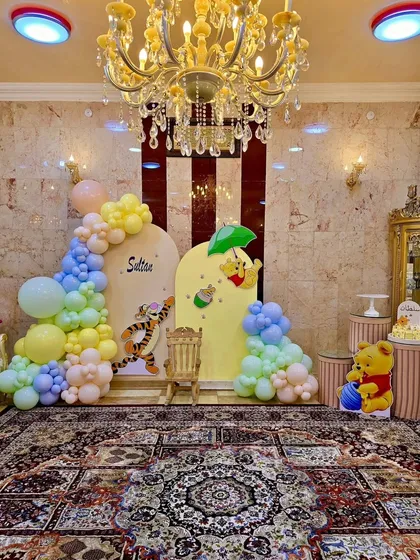 A classic Winnie the Pooh theme, perfect for a first birthday or baby shower. We used soft pastel balloons and character cutouts of Pooh and Tigger to bring the Hundred Acre Wood to this cozy home celebration.