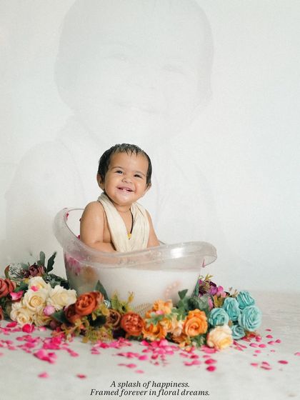 An artistic edit of the bath time shoot, with a faint overlay of the baby's face, adding a dreamy and memorable quality to the portrait.