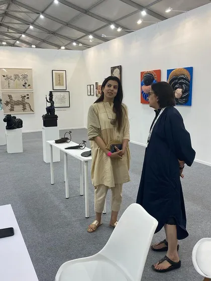Artist Reena Saini Kallat visiting our booth and speaking with our director.