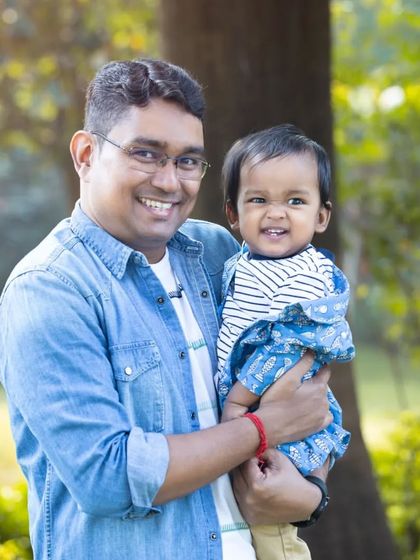 "Masti with Papa." A father holds his giggling son, both sharing a wide, happy smile. This candid shot perfectly captures the fun and playful side of their relationship.