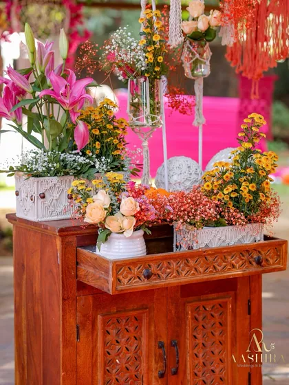 Another view of the floral-adorned cabinet, with a drawer pulled out to hold a small vase of flowers, adding a playful touch.