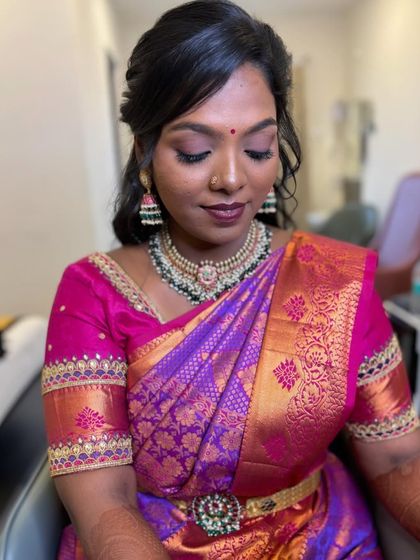 The complete reception look for Priyanka. The skin-like airbrush base, smokey eyes, and elegant hairstyle create a stunning overall effect.