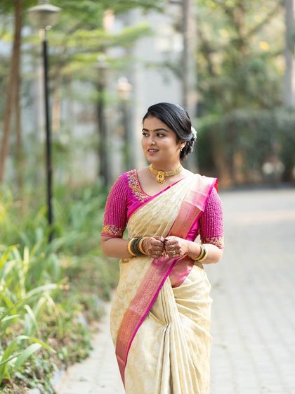 A lovely outdoor portrait from a pre-wedding ritual. The bride's makeup is fresh and glowing, and her simple, elegant saree is perfect for the occasion.
